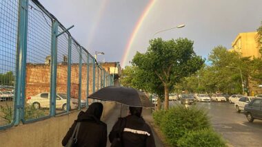Two Iranian women walk under a rainbow in downtown Tehran, Iran